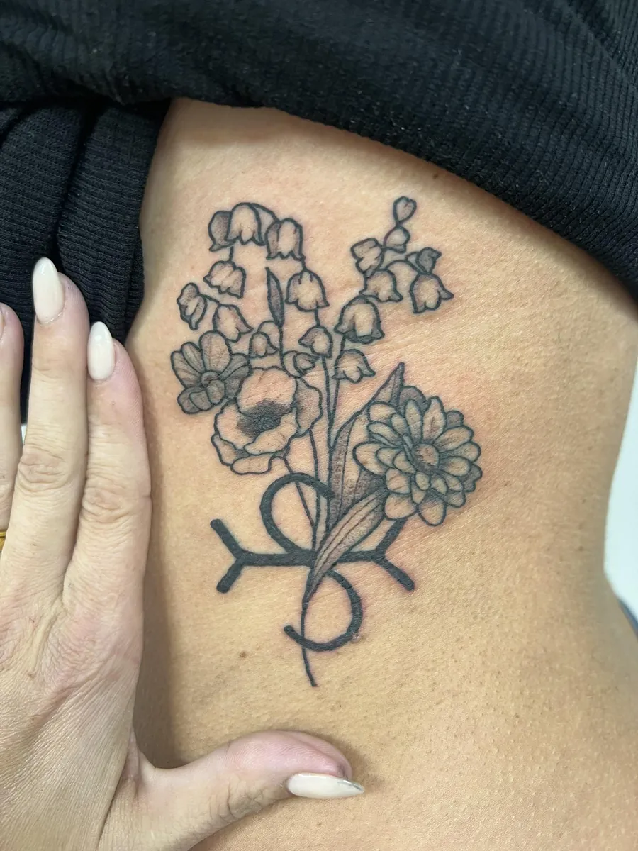 Birth flowers with zodiac glyph — side / ribs, fine line