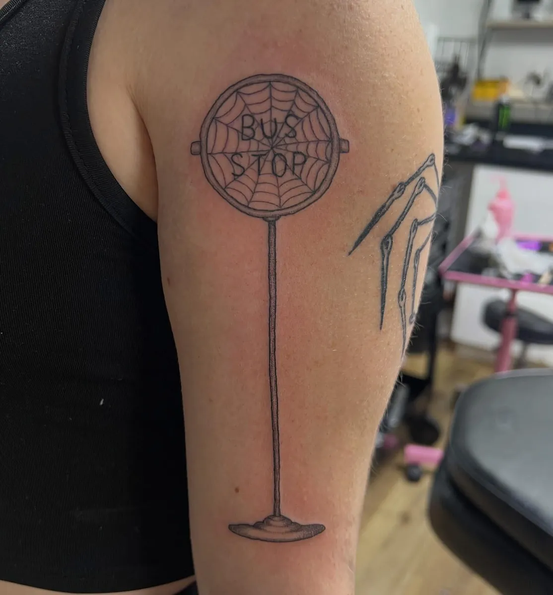 "BUS STOP" sign with spider web — upper arm linework