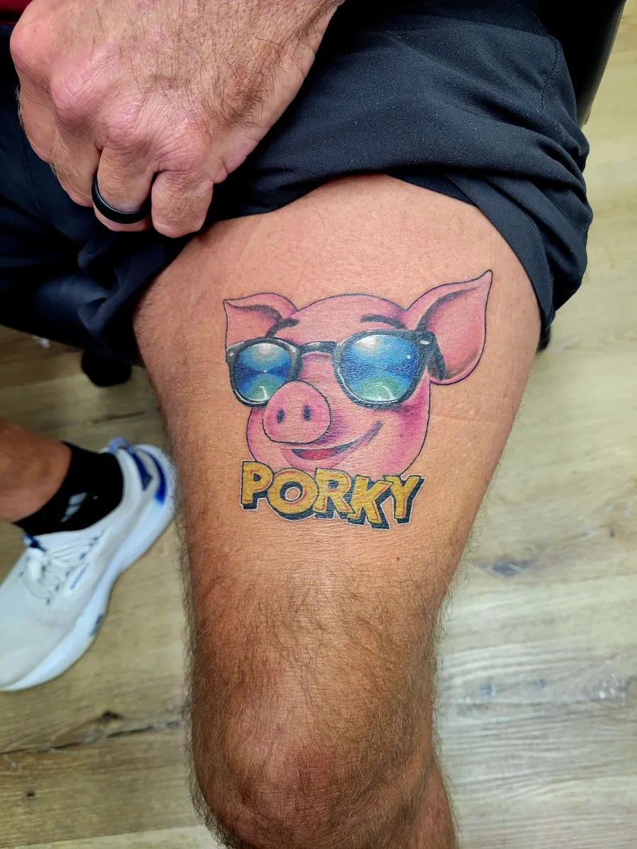 "PORKY" — pig in sunglasses, color, on thigh