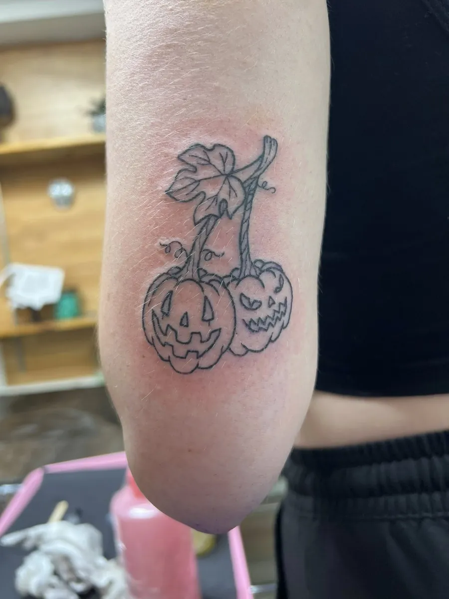 Linework jack-o-lantern duo on the arm