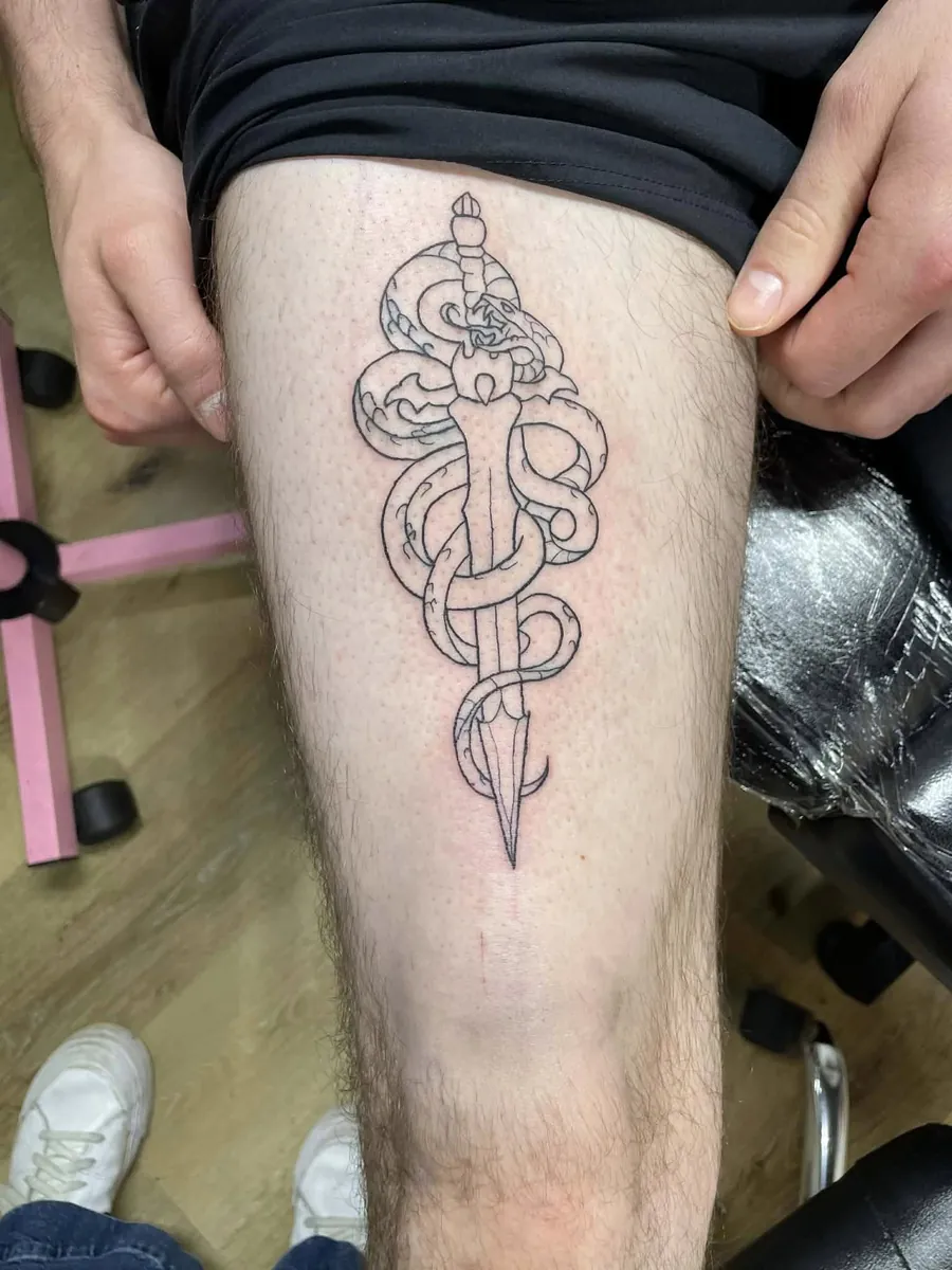 Snake wrapped around dagger — thigh linework