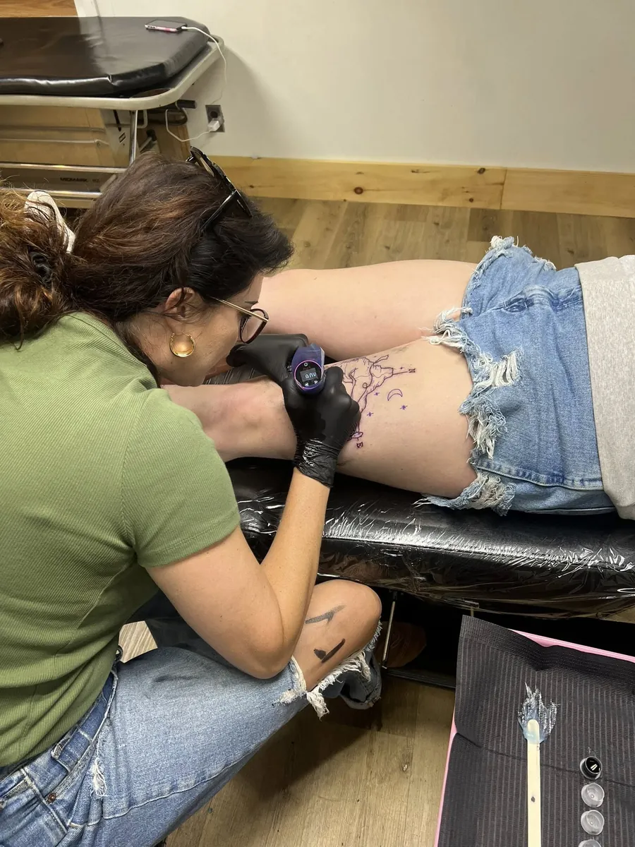 Sabrina at work — peony stencil on hip